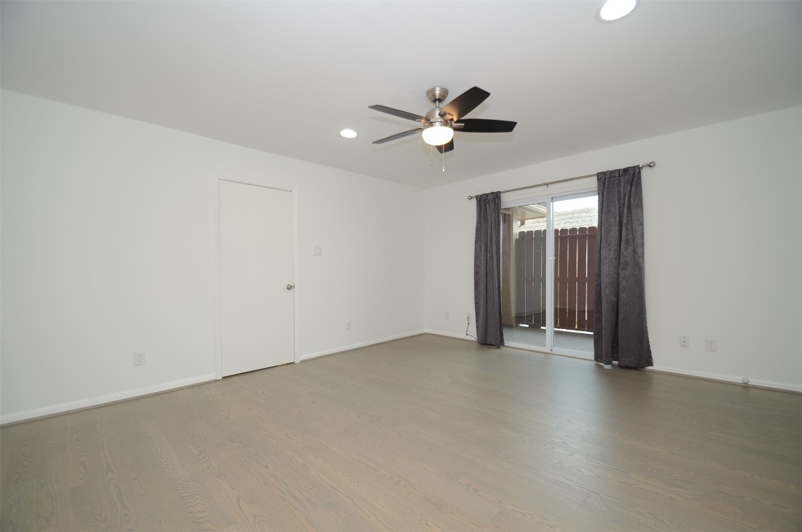5524 Beverly Hill Street, Unit 2 Houston, TX 77056 - Photo 20 of 43 a view of a room with wooden floor and ceiling fan