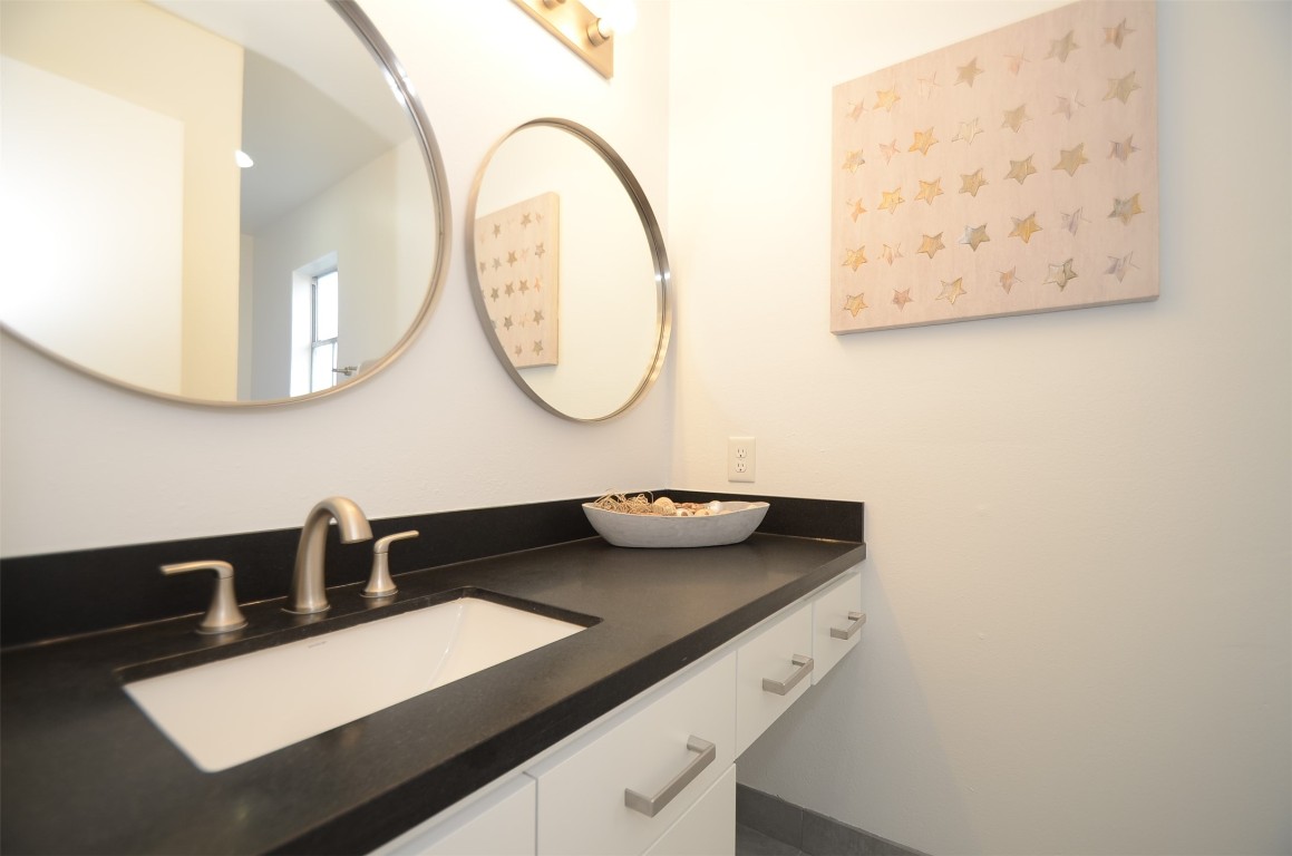 5524 Beverly Hill Street, Unit 2 Houston, TX 77056 - Photo 23 of 43 a bathroom with a sink and a mirror