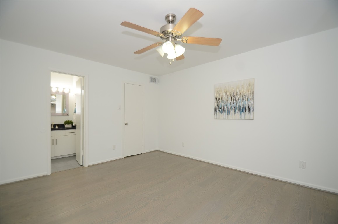 5524 Beverly Hill Street, Unit 2 Houston, TX 77056 - Photo 29 of 43 wooden floor in an empty room with a window