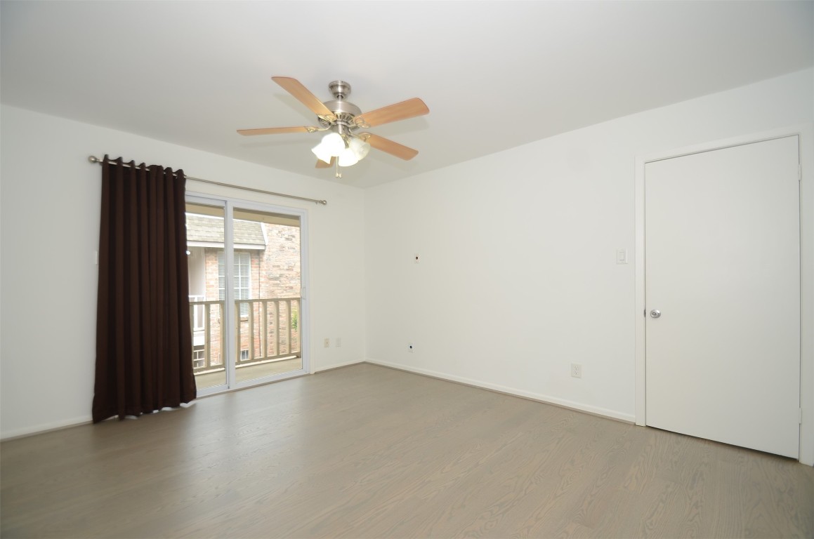 5524 Beverly Hill Street, Unit 2 Houston, TX 77056 - Photo 30 of 43 an empty room with windows and fan