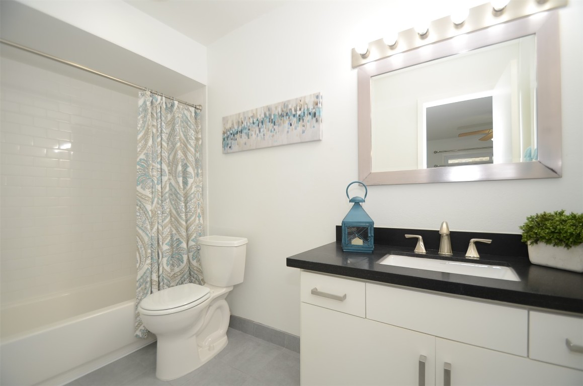 5524 Beverly Hill Street, Unit 2 Houston, TX 77056 - Photo 31 of 43 a bathroom with a toilet a sink and mirror