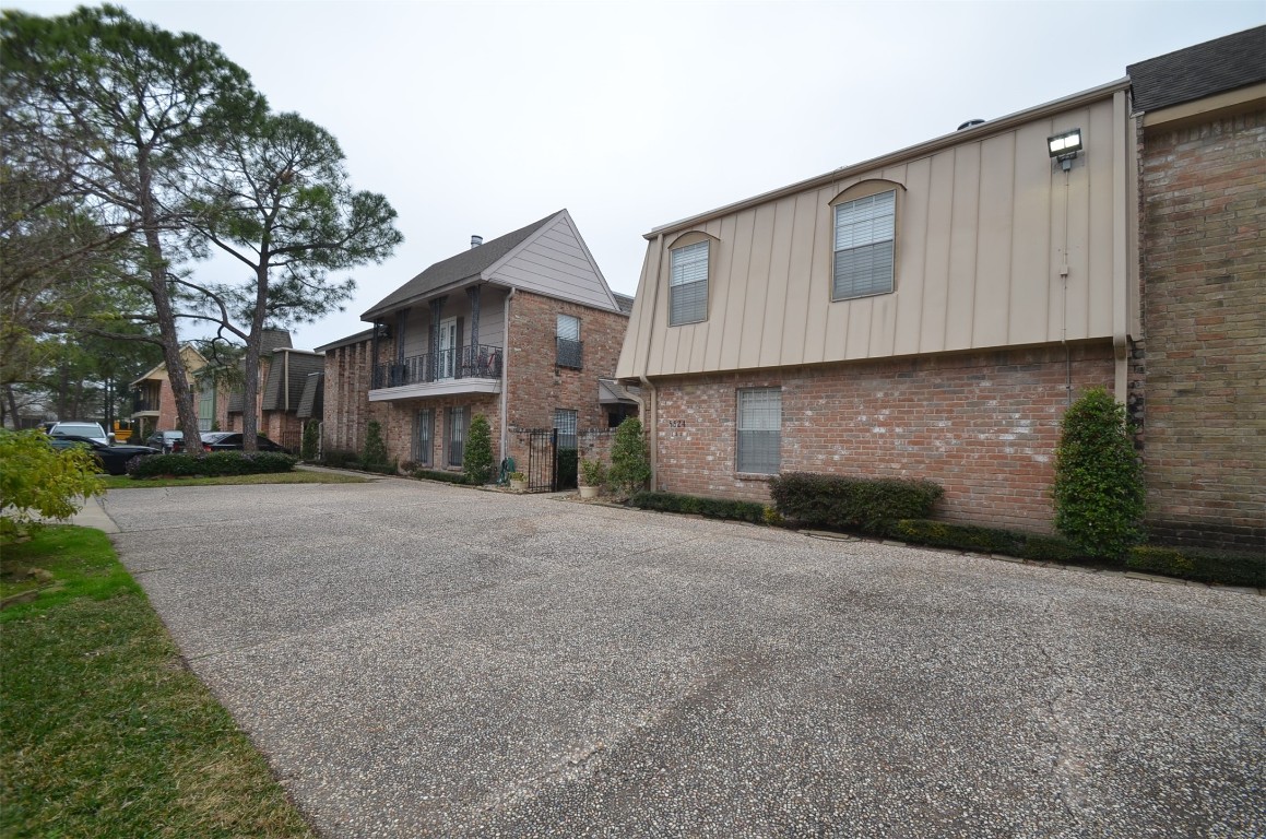 5524 Beverly Hill Street, Unit 2 Houston, TX 77056 - Photo 39 of 43 a front view of a house with a yard