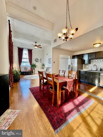 a kitchen with stainless steel appliances granite countertop a refrigerator a stove and a sink