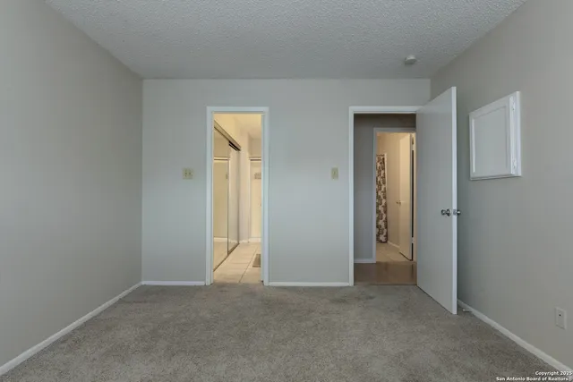 a view of an empty room and closet area