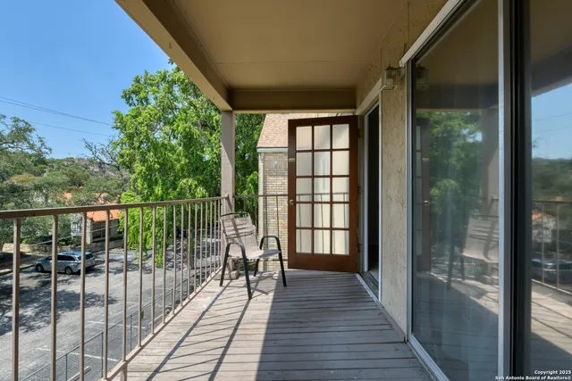 a view of a balcony with wooden floor