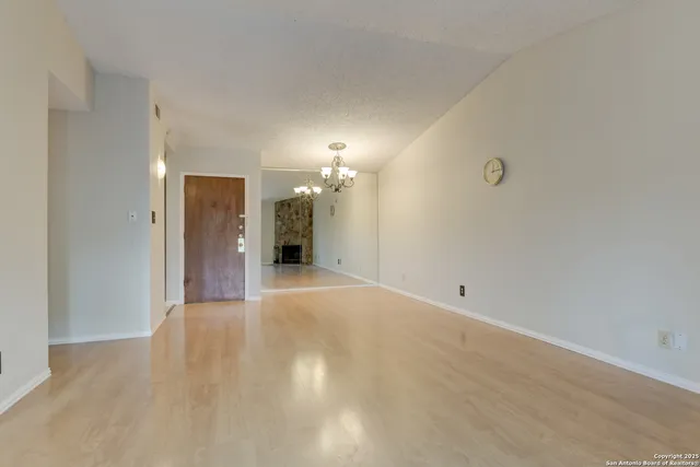 a view of a big room with wooden floor and a bathroom