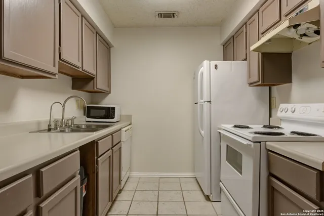 a kitchen with a stove and a sink