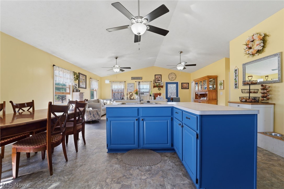 2932 Sexton Road Geneva, OH 44041 - Photo 41 of 41 Kitchen with blue cabinets, an island with sink, light countertops, and open floor plan