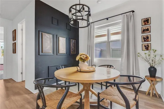a view of a dining room with furniture wooden floor and chandelier