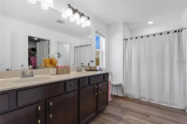 a bathroom with a double vanity sink and a mirror