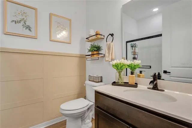 a bathroom with a sink a toilet and mirror