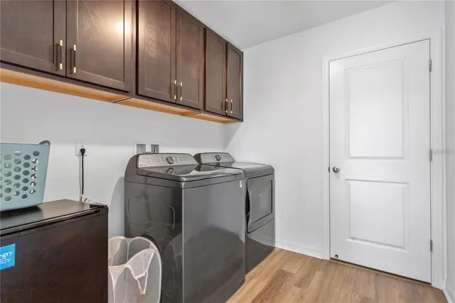 a utility room with closet dryer and washer