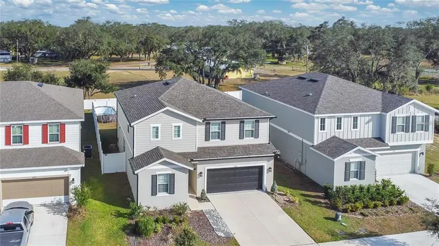an aerial view of a swimming pool with outdoor seating