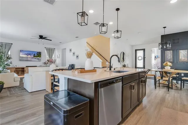 a kitchen with sink stove and wooden cabinets