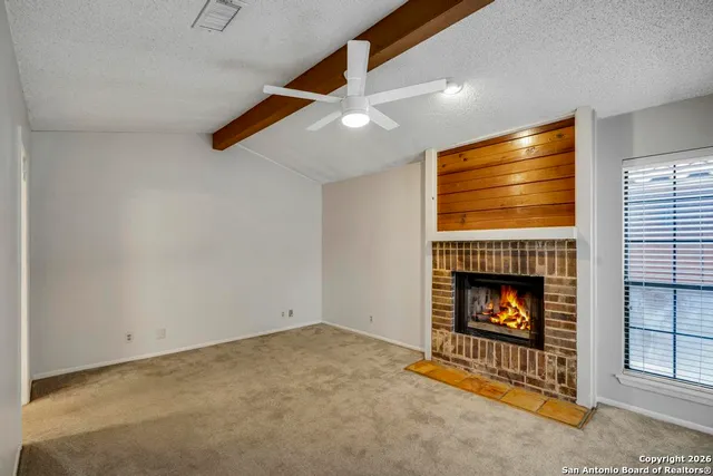 a living room with fireplace and a fireplace