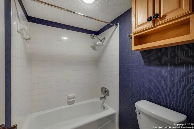a bathroom with a toilet a sink and bathtub