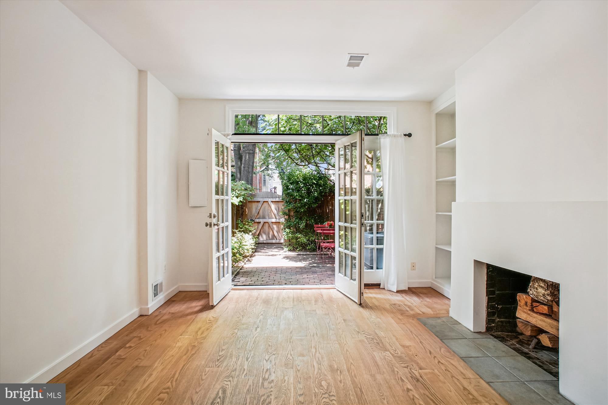1229 Portner Road Alexandria, VA 22314 - Photo 15 of 47 an empty room with wooden floor and fireplace