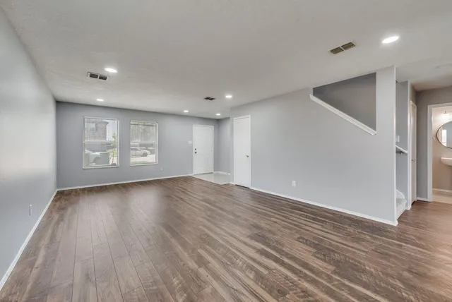 a view of a livingroom with wooden floor and window