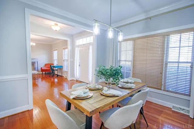 a living room with furniture and a flat screen tv with wooden floor