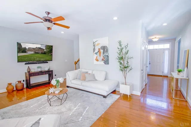 a living room with furniture and wooden floor