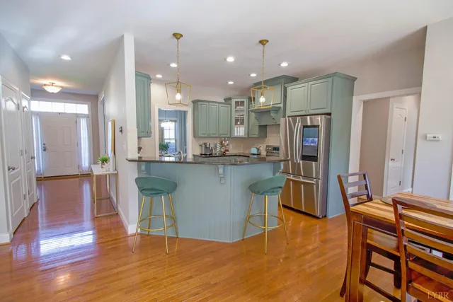 a kitchen with stainless steel appliances granite countertop a sink a stove and cabinets