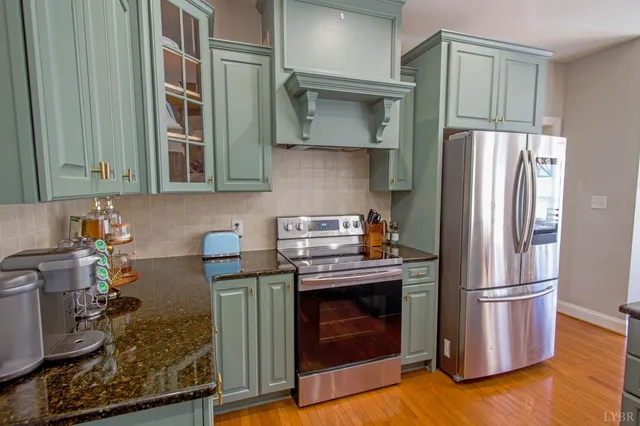 a view of a dining room with furniture a kitchen and chandelier