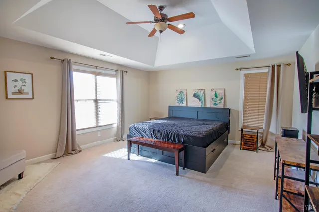 a bedroom with furniture and a flat screen tv