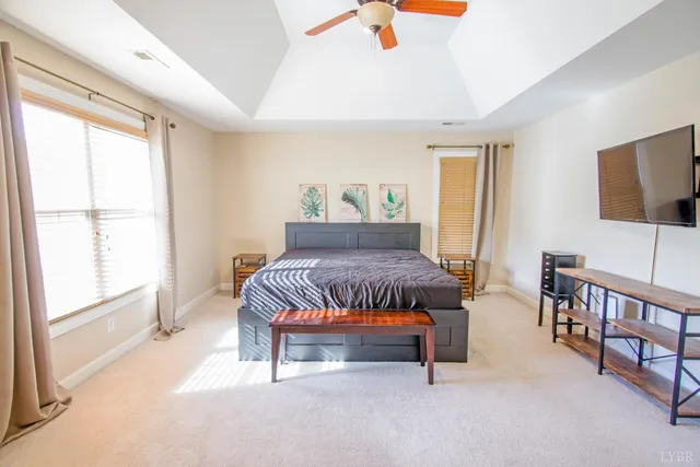 a spacious bedroom with a bed furniture and a window