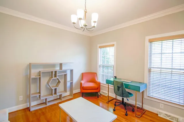 a view of a dining room with furniture and wooden floor
