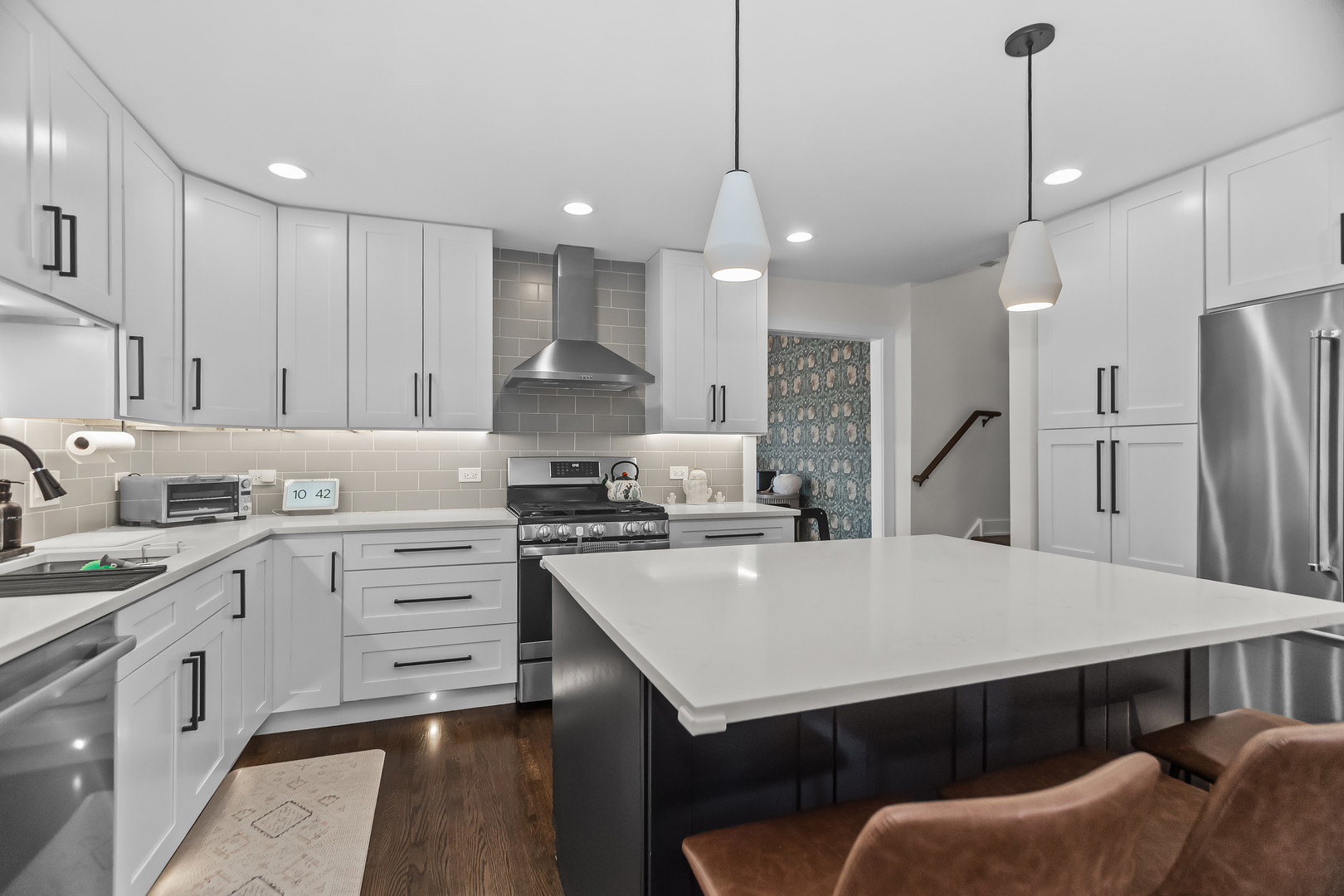 3240 Pitcher Drive Darien, IL 60561 - Photo 12 of 43 a kitchen with stainless steel appliances a stove a sink a refrigerator a center island and chairs