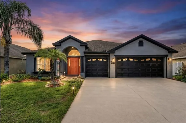 a front view of a house with a yard and garage