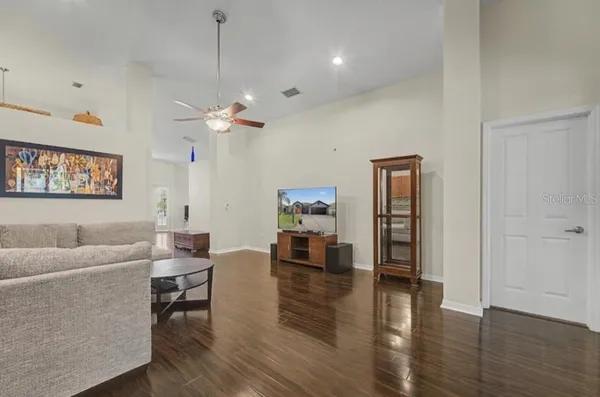 a kitchen with granite countertop a stove top oven cabinetry and garage