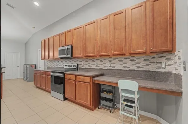 a kitchen with stainless steel appliances a refrigerator and a sink