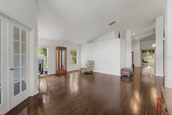 a view of a workspace with furniture and a window