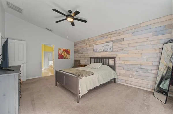 a bed sitting in a bedroom next to a window