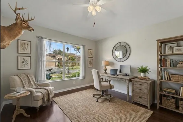 a view of a livingroom with furniture wooden floor and a window