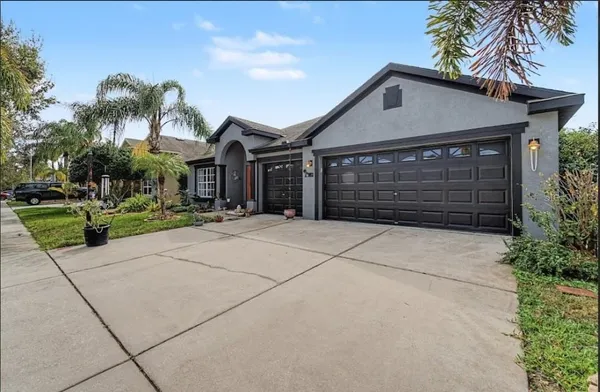 a front view of a house with a yard and garage
