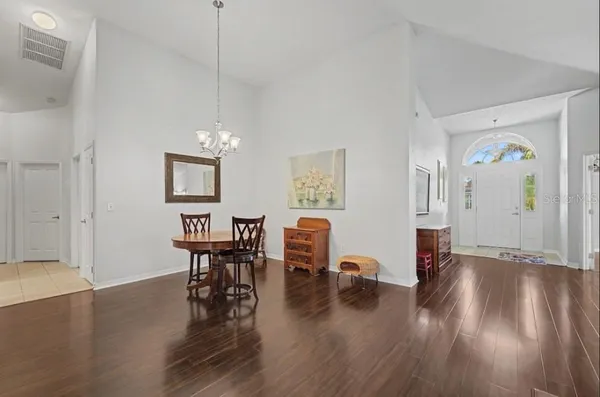 a living room with furniture and kitchen view
