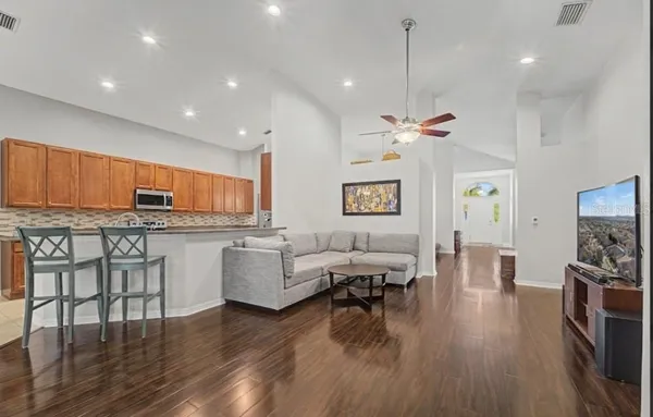 a living room with furniture and a chandelier