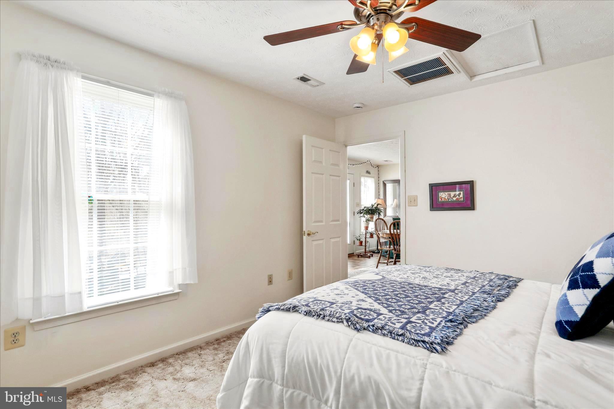 573 Lewis Street Front Royal, VA 22630 - Photo 17 of 45 a bedroom with a bed chandelier and a window