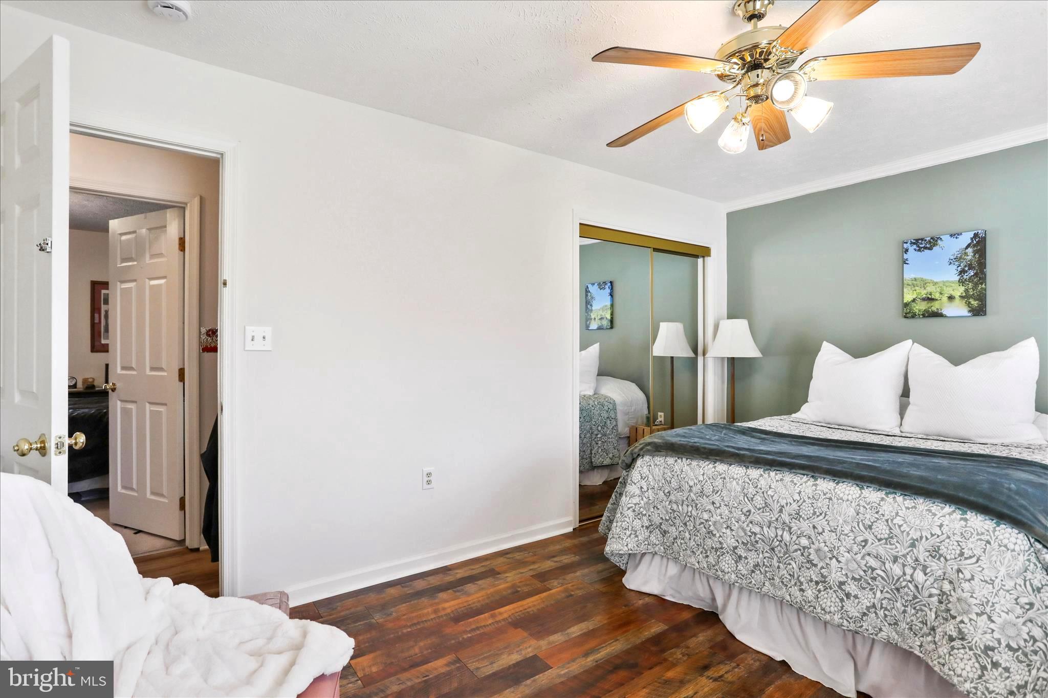 573 Lewis Street Front Royal, VA 22630 - Photo 25 of 45 a bedroom with a bed and a chandelier