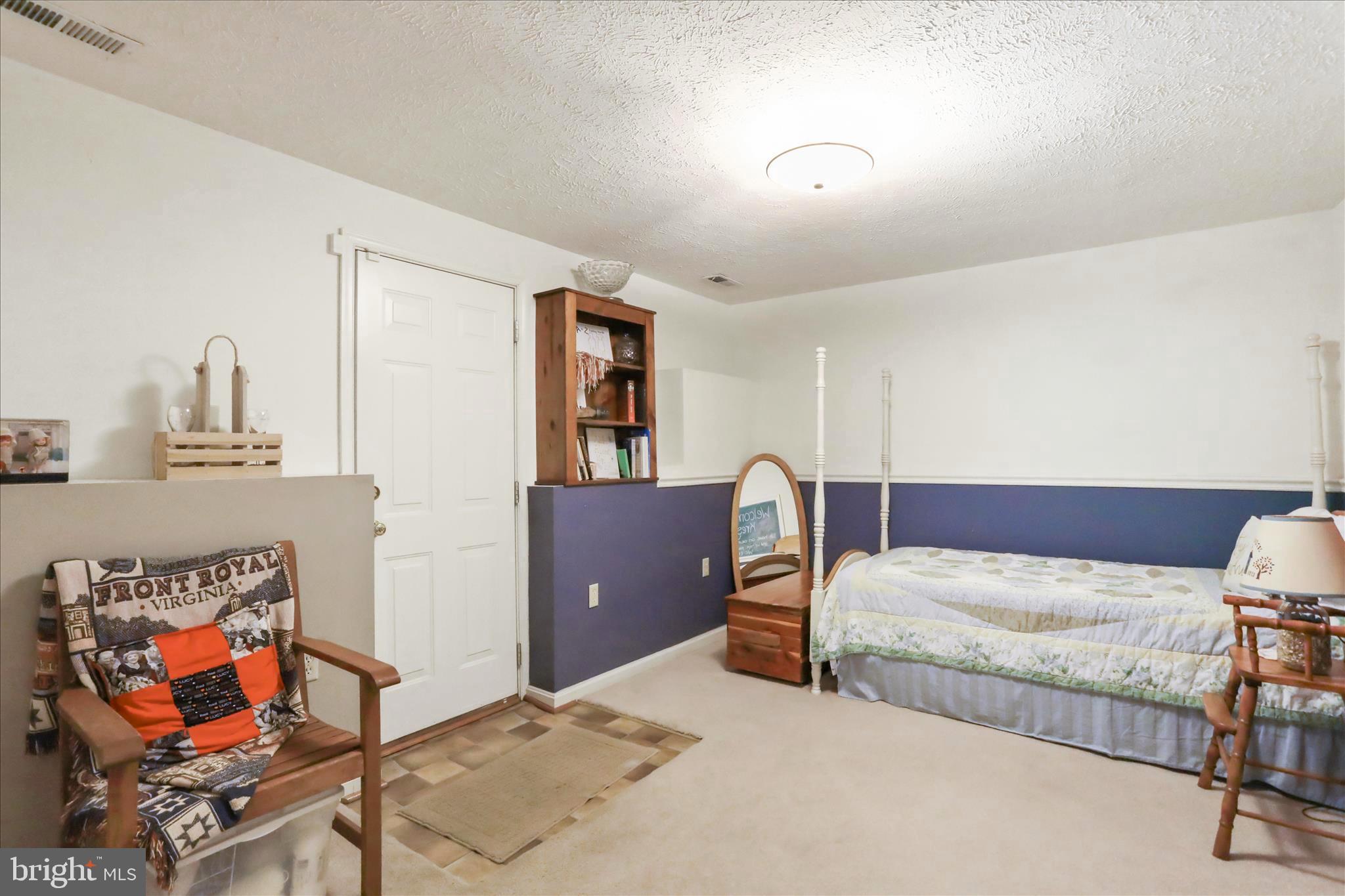 573 Lewis Street Front Royal, VA 22630 - Photo 32 of 45 a bedroom with a bed and wooden floor
