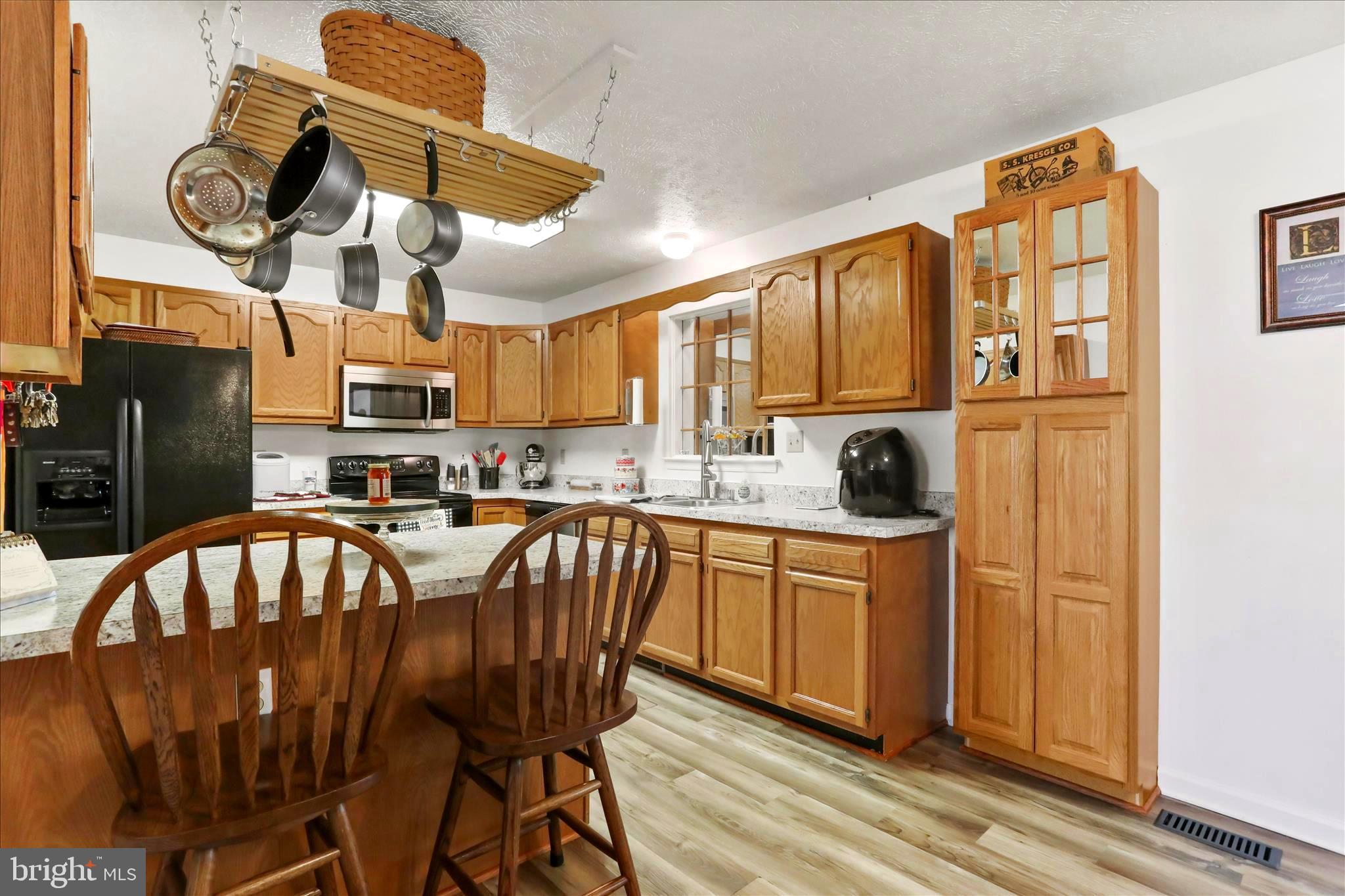 573 Lewis Street Front Royal, VA 22630 - Photo 7 of 45 a kitchen with stainless steel appliances granite countertop a stove a sink dishwasher and wooden cabinets