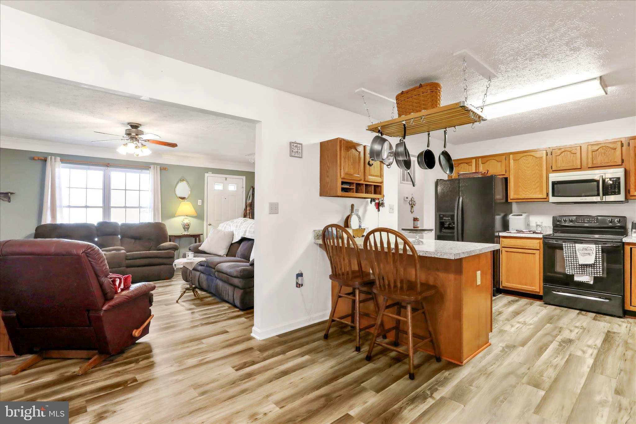 573 Lewis Street Front Royal, VA 22630 - Photo 8 of 45 a living room with furniture a flat screen tv and kitchen view
