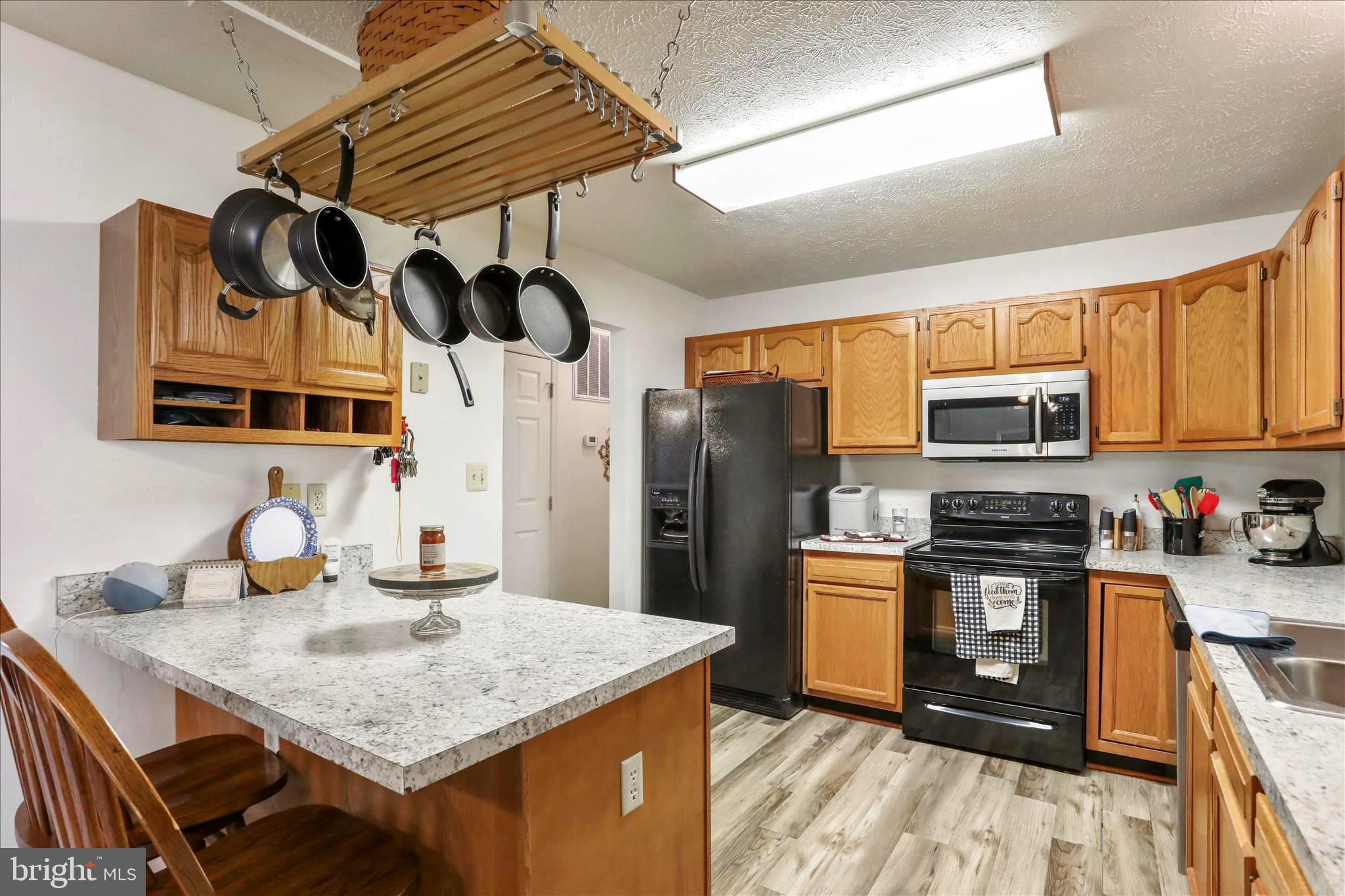 573 Lewis Street Front Royal, VA 22630 - Photo 9 of 45 a kitchen with stainless steel appliances granite countertop a sink a stove and refrigerator