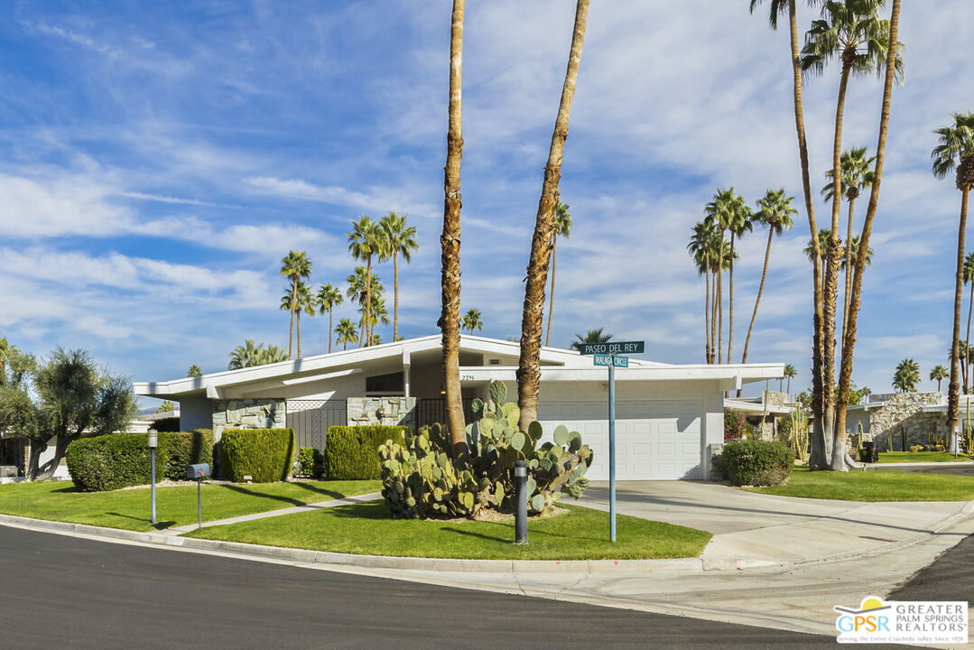 a front view of a building with garden