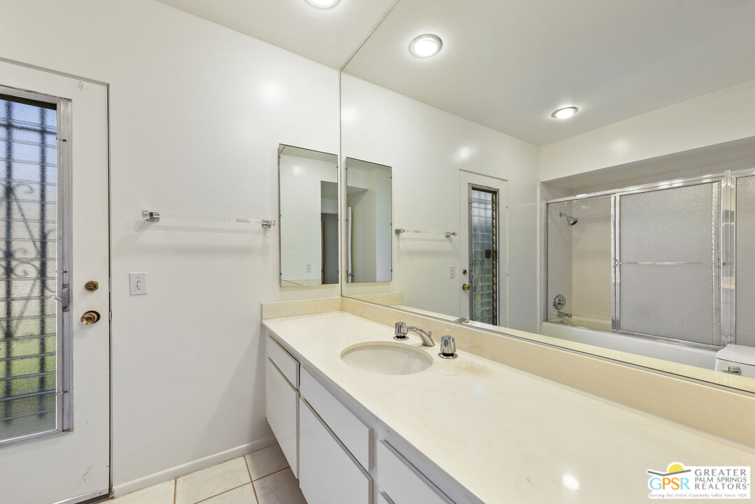 2296 Paseo Del Rey Palm Springs, CA 92264 - Photo 19 of 42 a bathroom with a double vanity sink mirror and shower