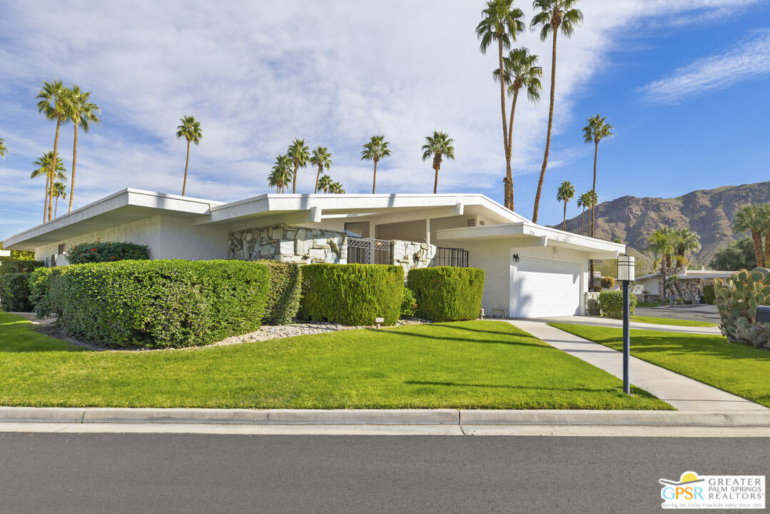 2296 Paseo Del Rey Palm Springs, CA 92264 - Photo 2 of 42 a front view of a house with a yard and potted plants