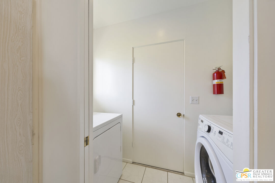 2296 Paseo Del Rey Palm Springs, CA 92264 - Photo 21 of 42 a utility room with dryer and washer