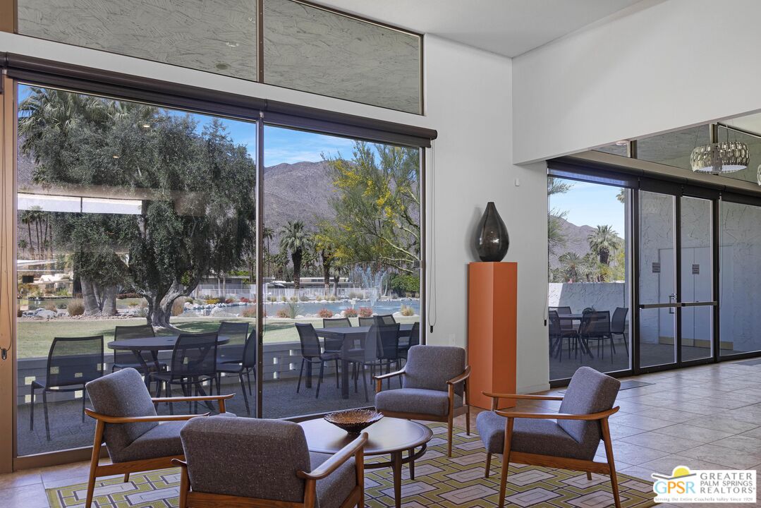 2296 Paseo Del Rey Palm Springs, CA 92264 - Photo 32 of 42 a view of a living room and floor to ceiling window and an outdoor kitchen